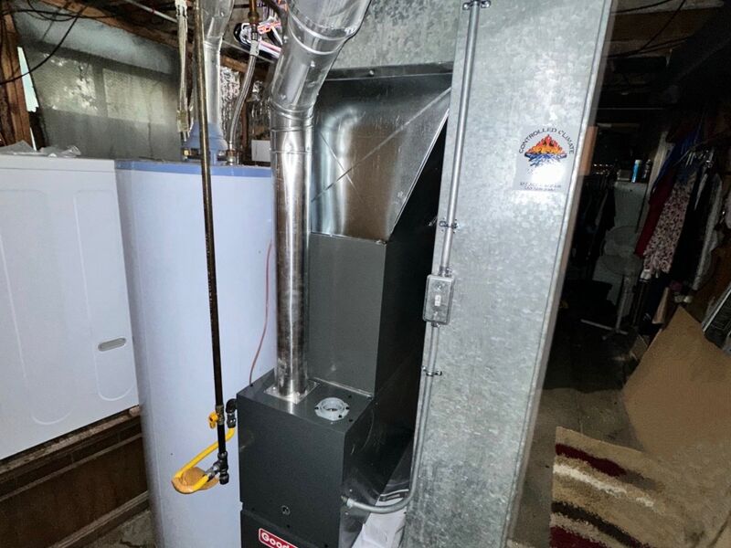 Goodman air conditioning condenser on a pad outside a Utah home